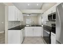 Modern kitchen boasts granite countertops, stainless steel appliances, and white cabinetry at 4607 N Country Hills Ct, Plant City, FL 33566