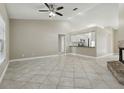 Open living room with tile flooring, high ceilings and view into the kitchen area at 4607 N Country Hills Ct, Plant City, FL 33566