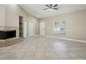 Spacious living room featuring a stone fireplace, tile flooring, and natural light at 4607 N Country Hills Ct, Plant City, FL 33566