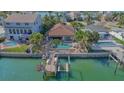Back of waterfront house featuring a private pool, and a boat dock at 487 Harbor S Dr, Indian Rocks Beach, FL 33785