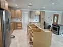 View of the kitchen featuring new cabinets, stainless steel refrigerator, oven, and new flooring at 538 Crystal Dr, Madeira Beach, FL 33708
