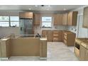 Spacious kitchen featuring new cabinets, stainless steel refrigerator, and marble floors at 538 Crystal Dr, Madeira Beach, FL 33708