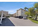 Exterior angle shot of condo building showing covered parking spaces at 5725 80Th N St # 301, St Petersburg, FL 33709