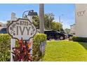 Close up shot of community sign, flowers, and building exterior at 5725 80Th N St # 301, St Petersburg, FL 33709