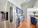 Modern kitchen featuring stainless steel appliances and stylish blue cabinets with ample counter space at 6001 Lemon Tree Ct, Tampa, FL 33625