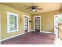 Inviting covered front porch with ceiling fan and wood flooring, a perfect place to relax and enjoy the outdoors at 6408 N Central Ave, Tampa, FL 33604