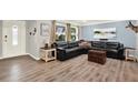 Bright living room with hardwood floors, a plush leather couch, and large windows for ample natural light at 6844 34Th N Ave, St Petersburg, FL 33710