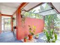 Enclosed outdoor space with tiled floors, a translucent roof, and view to the tropical backyard at 6865 Circle Creek Dr, Pinellas Park, FL 33781