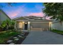 Beautiful home exterior featuring a paved driveway, well-maintained lawn, and solar panels for energy efficiency at 11130 Summer Star Dr, Riverview, FL 33579