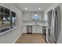 Modern kitchen featuring stainless steel appliances, bright lighting, and stylish backsplash at 1207 Chevy Chase Dr, Sun City Center, FL 33573
