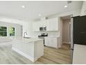 Bright kitchen with white cabinets, stainless steel appliances, and a large center island at 12758 Oak Hill Way, Parrish, FL 34219
