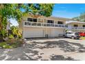Two-story townhouse with a spacious balcony above the two-car garage and a paved driveway at 1813 Bough Ave # B, Clearwater, FL 33760