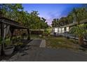 Spacious backyard with a gazebo, string lights, lush landscaping, and a dark exterior home at 2026 Union S St, St Petersburg, FL 33712