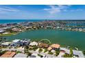 Aerial view of the property showcasing its waterfront location, private dock, and proximity to the beach at 208 Bath Club N Blvd, North Redington Beach, FL 33708