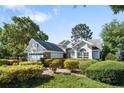 Beautifully landscaped single-Gathering home with an attached two-car garage and lush green lawn at 2182 Trevor Rd, Palm Harbor, FL 34683