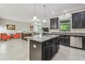 Modern kitchen with granite countertops, stainless steel appliances, and a breakfast bar at 28568 Tranquil Lake Cir, Wesley Chapel, FL 33543