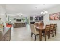 Open concept living space featuring tiled flooring and a smooth transition to the kitchen at 28568 Tranquil Lake Cir, Wesley Chapel, FL 33543