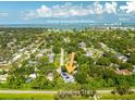Stunning home aerial view near Belleair Beaches and Country Club, featuring Clearwater Beach on the horizon at 321 Barbara Cir, Belleair, FL 33756