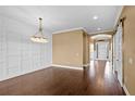 Formal dining room with beautiful hardwood floors, decorative lighting and wainscoting at 3214 Forsythia Dr, Odessa, FL 33556