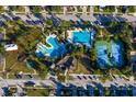Community aerial shot featuring pools, tennis courts, and lush landscaping at 33854 Floating Heart Ct, Wesley Chapel, FL 33545