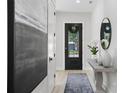 Bright and airy entryway features stylish decor, a modern door, and eye-catching artwork at 468 44Th N Ave, St Petersburg, FL 33703
