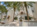 Upscale building exterior featuring a gated entry, well-manicured greenery, and an address plaque at 610 S Rome Ave # 602, Tampa, FL 33606