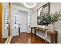 Stylish foyer with hardwood floors, display cabinets, and a decorative console table and mirror at 610 S Rome Ave # 602, Tampa, FL 33606