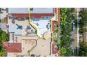 Aerial view of a spacious rooftop terrace with lounge seating, dining area, and lush landscaping at 610 S Rome Ave # 602, Tampa, FL 33606
