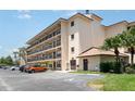 Exterior view of condo building featuring multiple levels, balconies, parking, and convenient handicap access at 635 30Th W Ave # F309, Bradenton, FL 34205