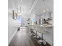 Modern kitchen with sleek white cabinets, granite countertops, stainless steel appliances, and stylish bar seating at 777 N Ashley Dr # 2312, Tampa, FL 33602