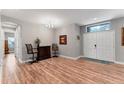 Inviting foyer with stylish wood flooring, bar table, and abundant natural light at 7809 E 114Th Ave, Temple Terrace, FL 33617