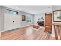 Comfortable living room featuring wood floors, a piano, and bright window at 7809 E 114Th Ave, Temple Terrace, FL 33617
