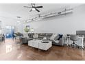 Open living room featuring polished floors, modern decor, a gray leather couch, and a large sliding glass door at 851 3Rd Ave N, St Petersburg, FL 33701