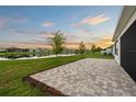 A backyard patio offers a beautiful view of the lake and the surrounding community at 8612 Ivy Stark Blvd, Wesley Chapel, FL 33545