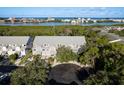 Aerial view of townhomes near a scenic waterfront with city views at 9660 Tara Cay Ct # 38, Seminole, FL 33776