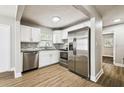 Bright kitchen features stainless steel appliances, white cabinets, and stylish countertops at 10215 N 23Rd St, Tampa, FL 33612