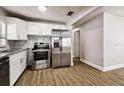 Well-lit kitchen with modern stainless steel appliances and white cabinetry at 10215 N 23Rd St, Tampa, FL 33612