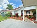 Cozy single-story home boasting a well-maintained lawn with vibrant landscaping and a functional carport at 10636 Millriver Dr, New Port Richey, FL 34654
