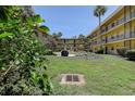 View of the courtyard featuring lush greenery and well-maintained landscaping at 11485 Oakhurst Rd # 310, Largo, FL 33771