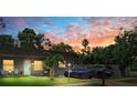 Cozy home with a well-kept lawn and a striking sunset backdrop, enhancing its curb appeal and inviting ambiance at 12316 Eldon Dr, Largo, FL 33774