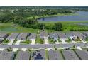 Aerial view of the home in a lakeside community with lush green surroundings, showcasing its desirable neighborhood location at 13735 Wineberry Dr, Dade City, FL 33525