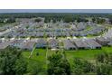 Aerial view of the home with a large backyard and partial fence, showing its location in a residential neighborhood at 13735 Wineberry Dr, Dade City, FL 33525