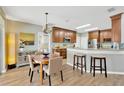 Cozy kitchen and dining area with hardwood floors, stainless steel appliances, and bar seating at 1649 Ledgestone Dr, Brandon, FL 33511