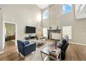Bright living room featuring high ceilings, a fireplace, and stylish furniture at 1649 Ledgestone Dr, Brandon, FL 33511