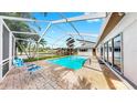 Enjoy the Florida lifestyle with this lovely pool featuring a screened enclosure and brick-paved deck at 2401 Roberta Ln, Clearwater, FL 33764