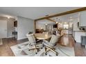 Open-concept living area with wood floors, a view of the kitchen, and neutral walls at 2914 Forest Cir, Seffner, FL 33584
