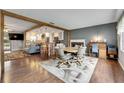 Open-concept living area with wood floors, a fireplace, and a view of the kitchen at 2914 Forest Cir, Seffner, FL 33584