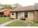 Inviting single-story home with neutral siding, a cozy front bench, and a well-kept lawn at 35077 Whispering Oaks Blvd, Dade City, FL 33523