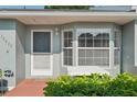 Inviting front entrance featuring a bay window and neat landscaping that enhances the home's curb appeal at 38237 Eucalyptus Dr, Zephyrhills, FL 33542