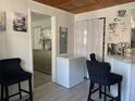 Bright kitchenette with charming coffee station, breakfast bar seating, and view to adjacent room at 4219 Gray Squirrel Ln, New Port Richey, FL 34653